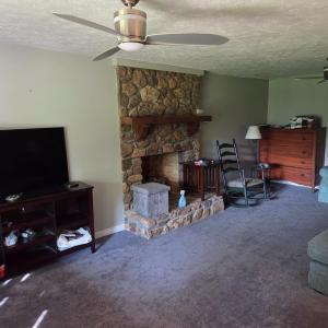 Den with rock fireplace