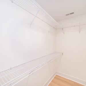 Walk in closet in primary bedroom.
