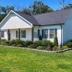 Professionally Designed Landscaping with Established Lawn, Concrete Borders, and Thoughtfully Planned Plantings.