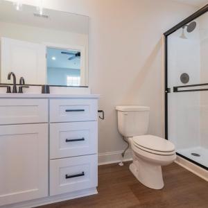 Primary Suite with vaulted ceilings, walk in closet and en suite full bathroom.