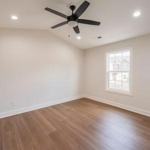 Primary Suite with vaulted ceilings, walk in closet and en suite full bathroom.