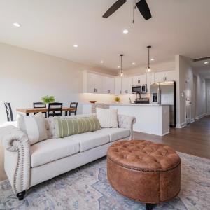 Open concept living room into dining and kitchen area on main floor.  Finishes may not be identical but similar.