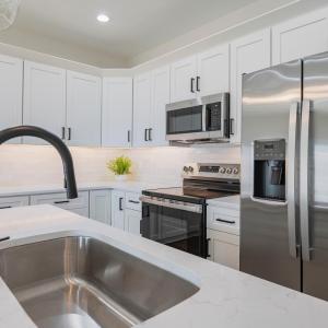 Custom kitchen with quartz counters, tile backsplash, all stainless applicants includes. Finishes may not be exact, but will be similar.