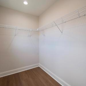 Primary Suite with vaulted ceilings, walk in closet and en suite full bathroom.