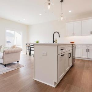Open concept living room into dining and kitchen area on main floor.  Finishes may not be identical but similar.