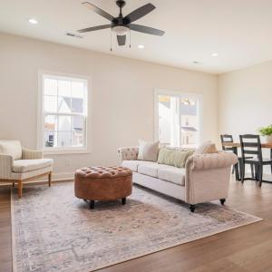 Open concept living room into dining and kitchen area on main floor.  Finishes may not be identical but similar.