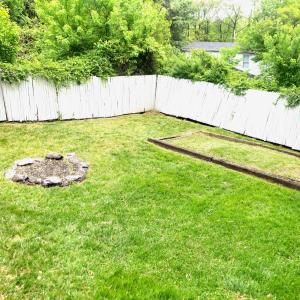 LARGE FENCED BACKYARD WITH FIRE PIT AND GARDEN SPACE