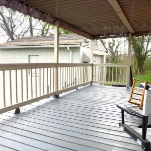 COVERED BACK PORCH OFF OF DINING ROOM OVERLOOKING FENCED BACKYARD