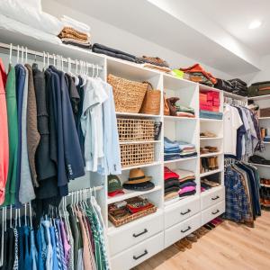 Primary walk in closet with added drawer space for more storage.