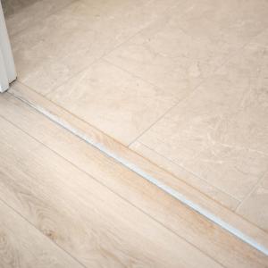 Neutral tile floor in primary bath ensuite