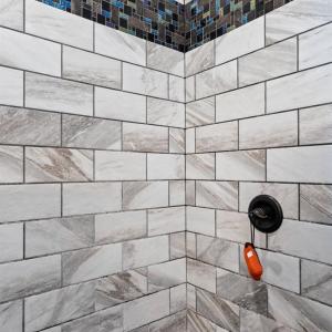 Primary shower and river stone shower floor.