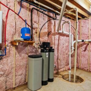 Tankless hotwater heater, water softener, and storage area.
