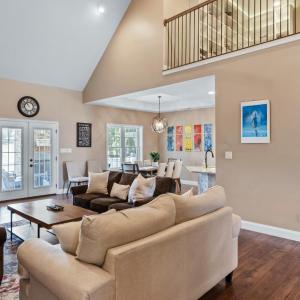 Living room with vaulted ceiling and stone wall fireplace.