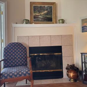 Just to the side of the Sunporch door is the gas logs fireplace.