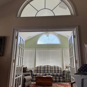 The SUNPORCH!! 3 walls of windows, french doors to close it off from the greatroom, double Palladian windows, and built in shelves around the entire wall with the french doors!