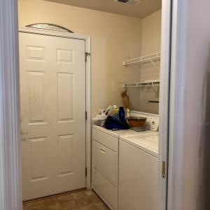 The laundry area door leads to the garage. Just outside the door is a utility laundry sink. Washer and dryer convey.