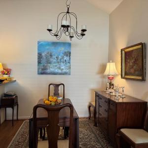 The formal Dining Room area is behind the Greatroom sitting area and to the side of the kitchen island.