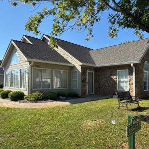 Stonegate Villas are set up as quads. The driveway off Salisbury Circle pulls around the left side of the house here at the sunporch and to the kitchen/laundry door.