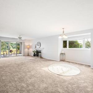 Open concept with lake and mountain views through double patio doors.