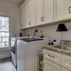 Separate Main Level Laundry Room - Washer/Dryer hook ups, oversized sink and lots of cabinets