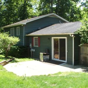 Rear view showing sliding glass doors leading into kitchen