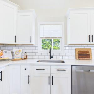 Granite Countertops, Large Kitchen Island, Stainless Steel Appliances, White Cabinetry, and Open Kitchen Design.