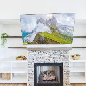 Fireplace / Built-Ins, Stone Fireplace with Custom Built-In Shelving creates a warm focal point for the Open Living Area.