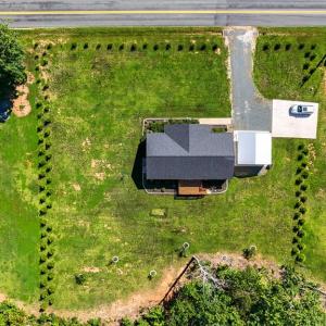 Arial View of Property, Established Apple and Peach Trees add beauty, seasonal enjoyment, and lasting value. 4 Arborvitae create Privacy, Beautiful Landscaping, and Year-Round Curb Appeal.