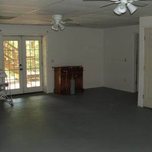 Large family room in basement.  French doors lead to patio.