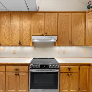 Primary Kitchen - Main Floor, Oak cabinets provide ample storage.