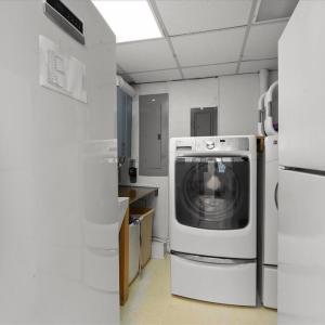 Utility Room, A Commercial On-Demand Hot Water Heater, Laundry Sink and Appliances, Freezer and an extra Refrigerator bring high functionality to the center of the home.
