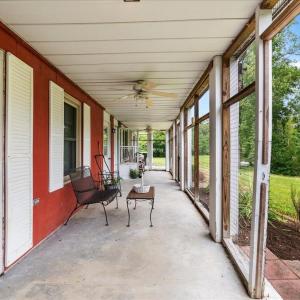 Ground Level Porch, Just steps away from the dock, this shady retreat immerses you in nature.  Separate entrances lead to two suites and a laundry center.