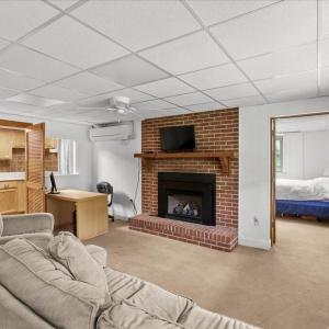 Living Room - Suite 1 Basement, Enjoy being cozy by the fireplace.