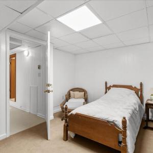 Swing Bedroom 6 - Basement, This can be an extra room for either suite in the basement, depending on which door is unlocked.