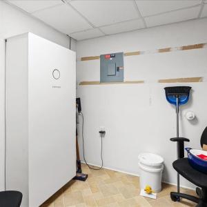 20 kW Battery Storage - basement, Solar energy is stored in this 20kW battery, reducing the household electrical utility demand and serving as a backup source during power outages.
