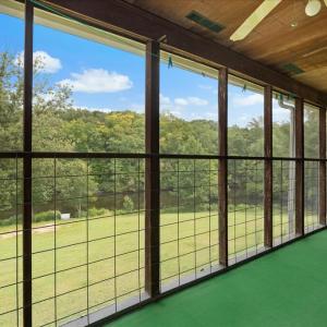 Wraparound Covered Porch - Main Level, A full-length covered porch provides outdoor dining, a canning stove, conversation areas, and access to serene immersion in nature.