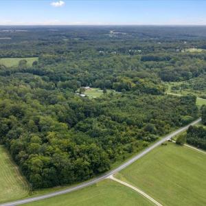 Aerial looking NE - VA-619 in foreground, Home is central in image, nestled into 100+ acres.
