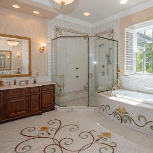 Impressive owner suite bath with mosaic design