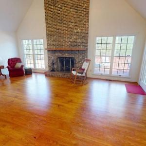 Family room with fireplace and wood floors.