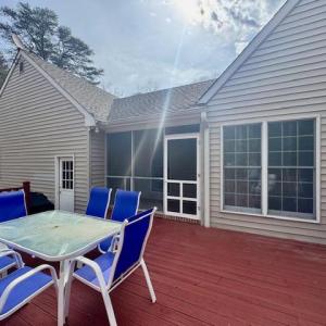 Rear deck leading into small creen porch.