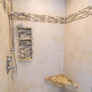 Tiled walkin shower in primary bedroom