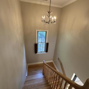 Stairs looking down with chandelier