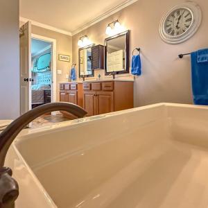 Main Primary Bathroom, With sinking Tub as well as a shower.