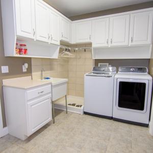 Laundry Room, Plenty of Storage, Folding Area, Drying Area. Door to the right leads to large storage closet.  The door to the left leads to the garage.