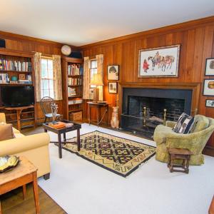 Den, Features include Fireplace and the staircase in the corner leads to one of two attic spaces.