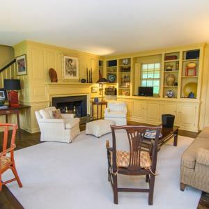 Library, Features include Fireplace, Built in cabinetry, Hidden closet, The doorway to the right leads out to the porch.