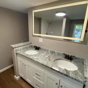 led mirror over granite topped vanity