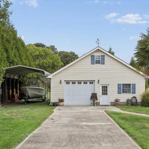 Detached garage with finished office space, workshop, and large back room with a sink