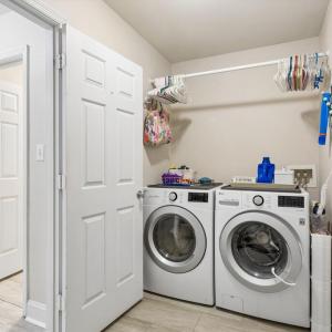 Utility room w/sink, laundry and entrance to 2 car attached garage