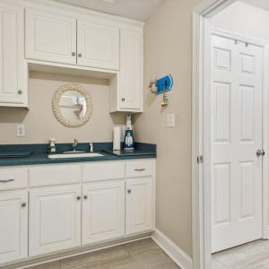 Utility room w/sink, laundry and entrance to 2 car attached garage